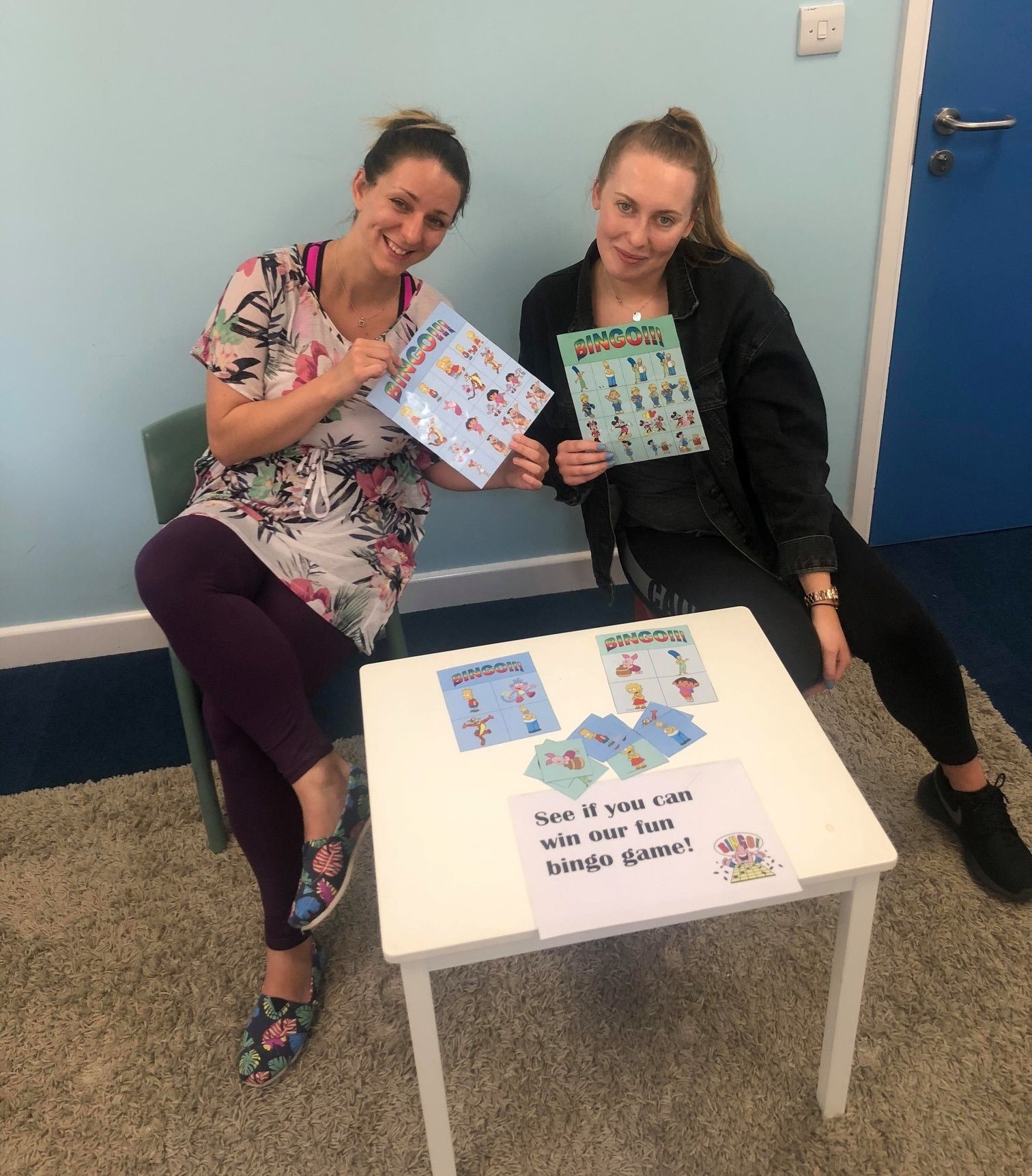 Researchers, Judit and Beth, show off the bingo game