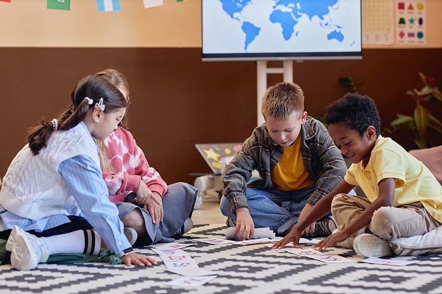 Children talking together as they work in a classroom.
