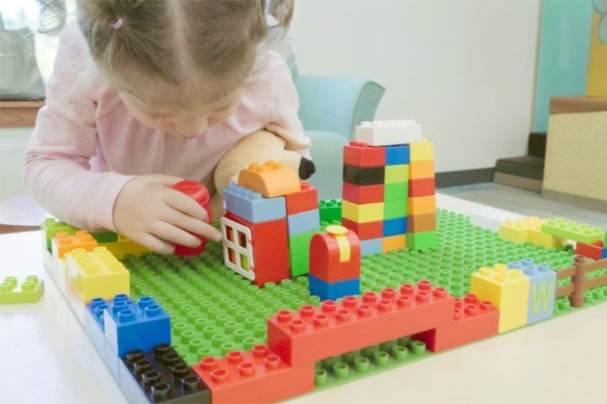 girl-playing-with-lego A young girl playing with lego.