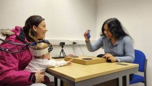 Baby with eeg net on taking part in a study