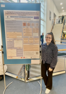 woman stood next to research poster